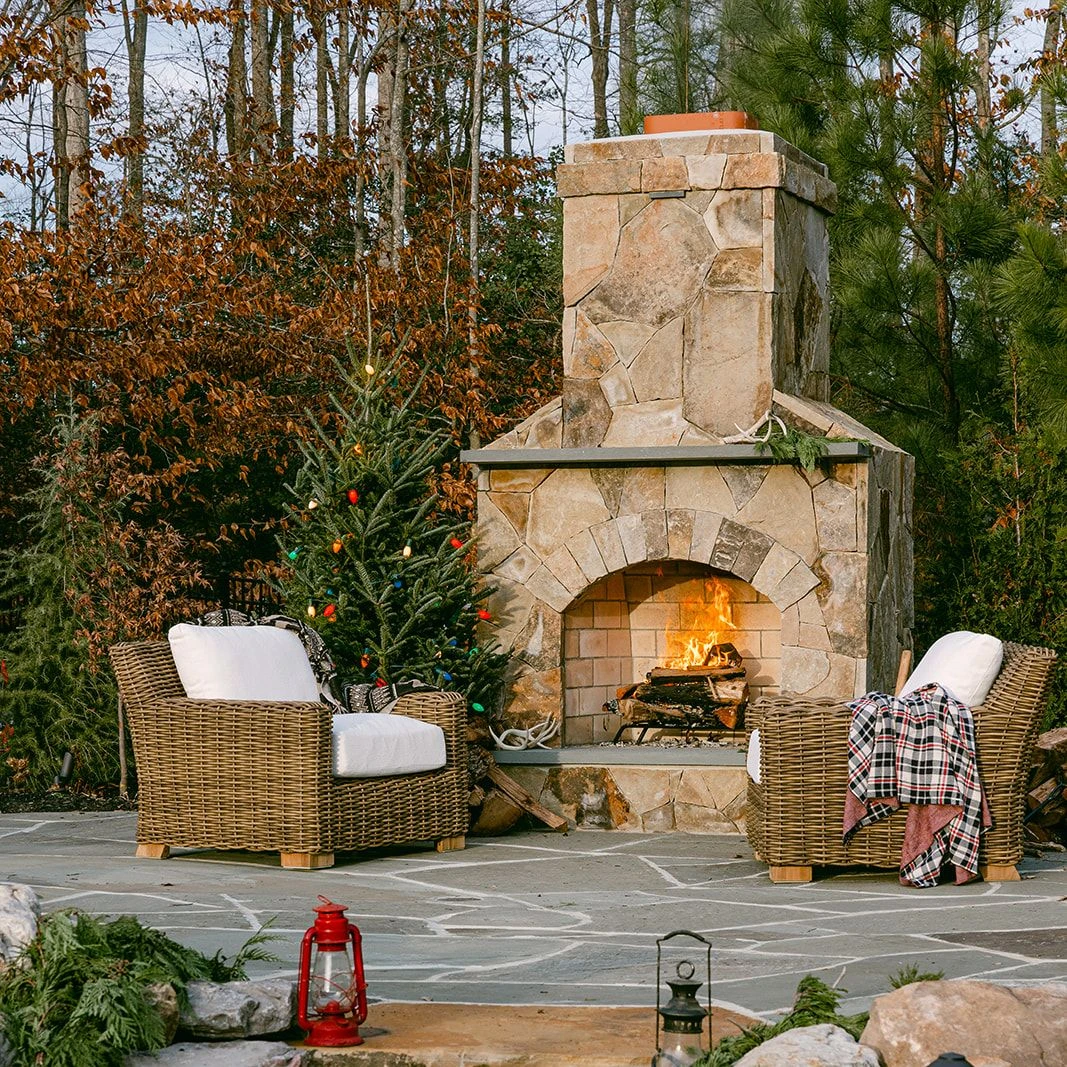 Chairs by fire pit styled with Christmas decorations
