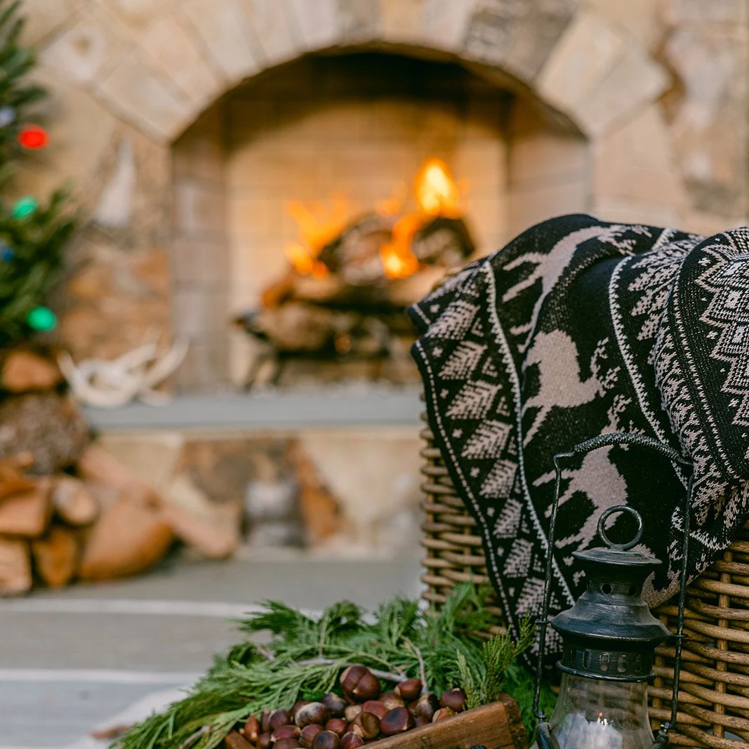 Outdoor holiday setup with vintage decor and fireplace