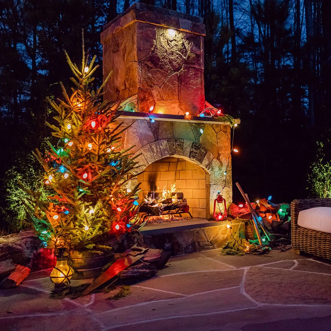 Outdoor seating by fire with rustic Christmas accents