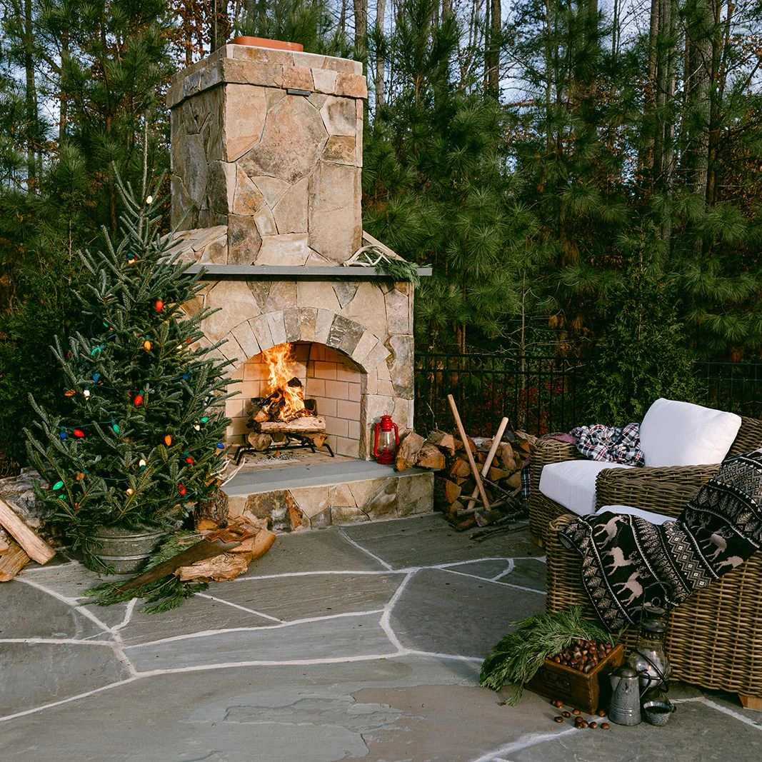 Stone and wood patio design with rustic holiday decor