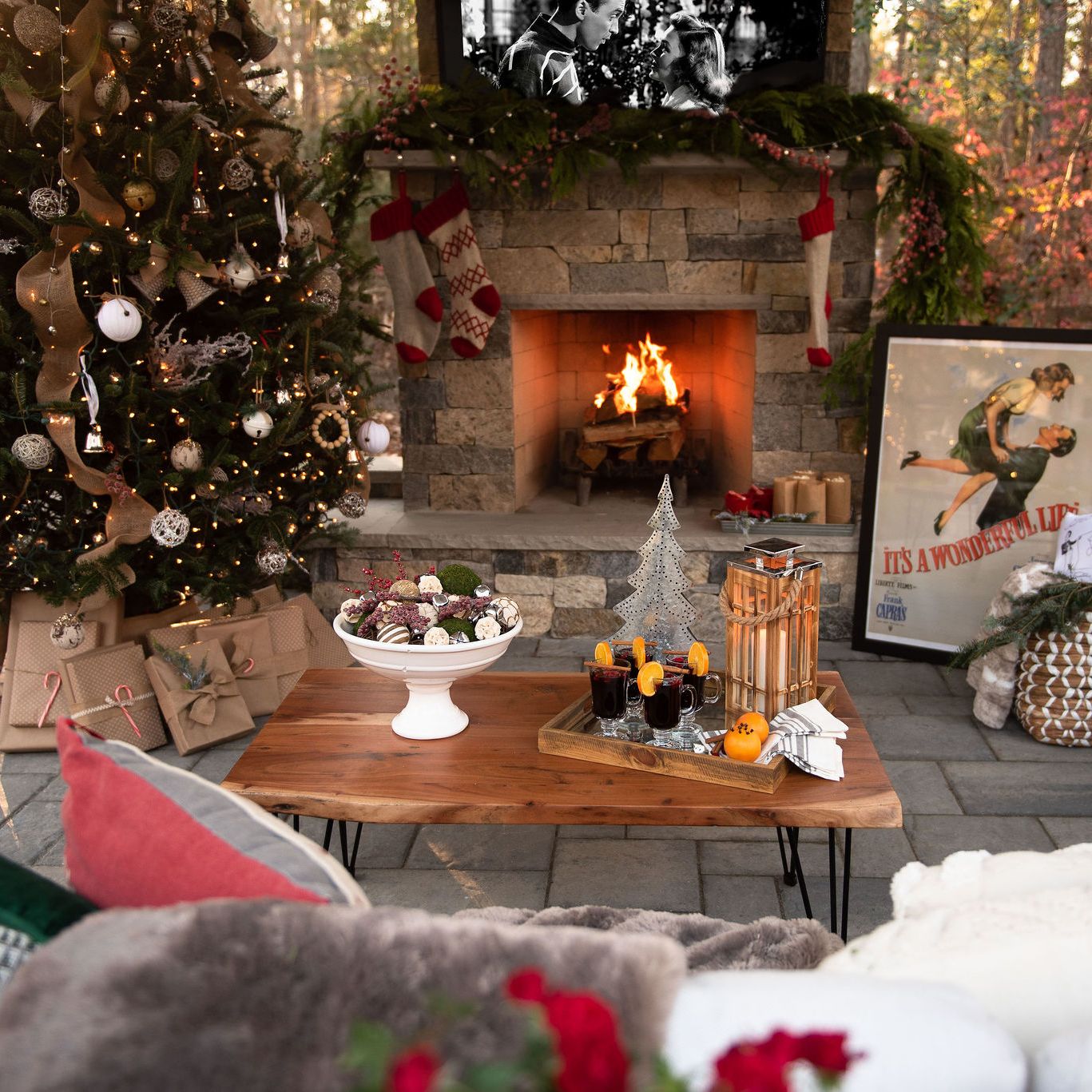 outdoor space decorated for the holidays with fireplace