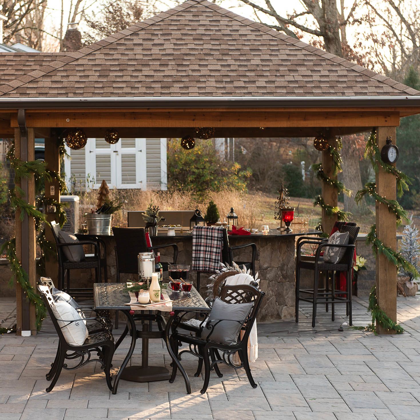 Festive patio setup with pavillion, string lights, and seasonal decor