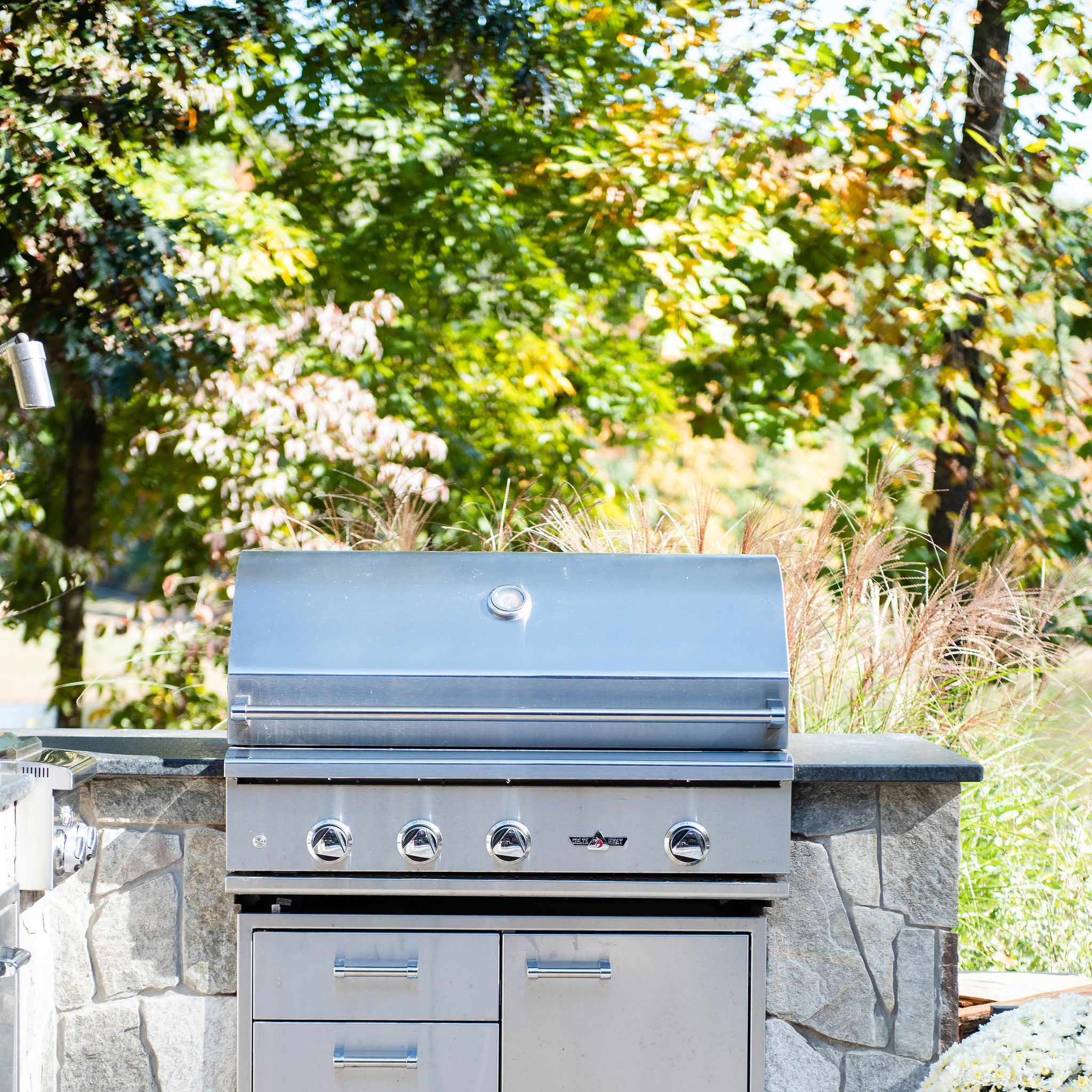 Bar-top outdoor kitchen with leathered granite countertop