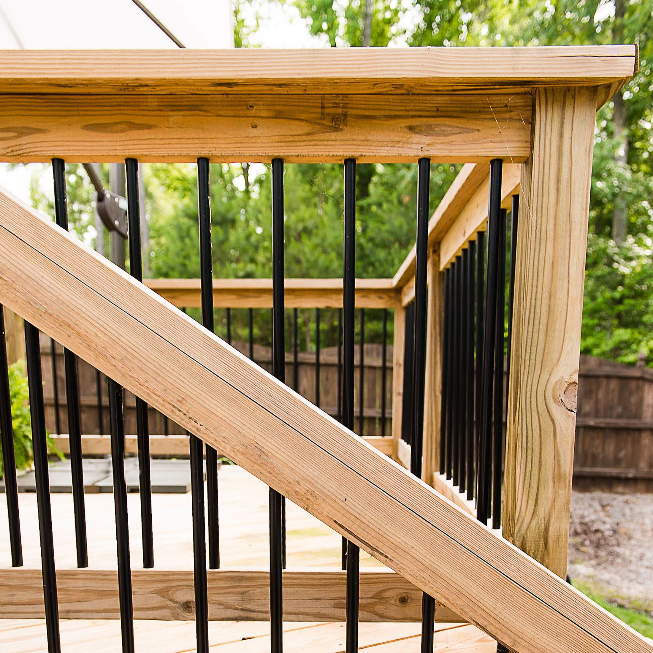 Wooden deck installed with black Round Balusters with metal