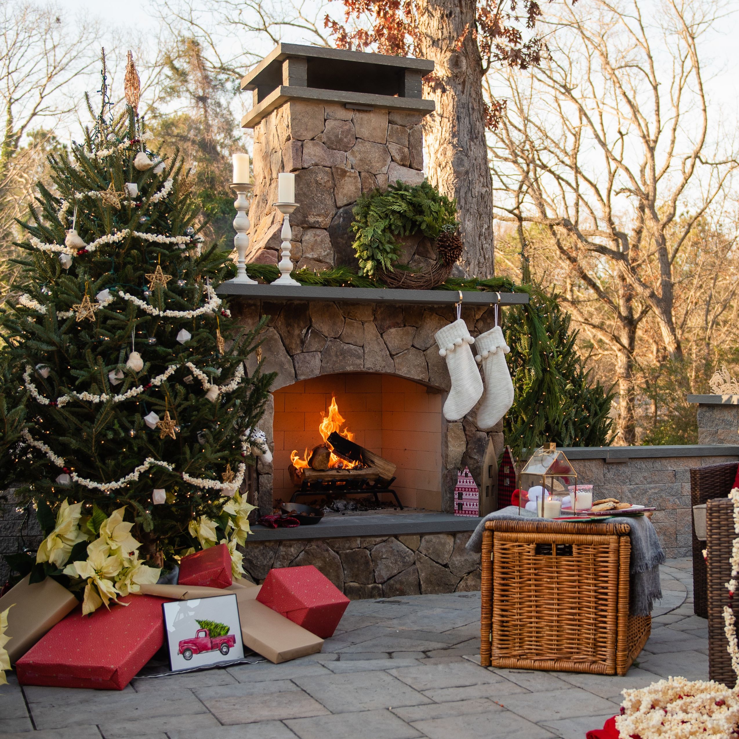 	Wreaths and garlands hang from festive outdoor fireplace