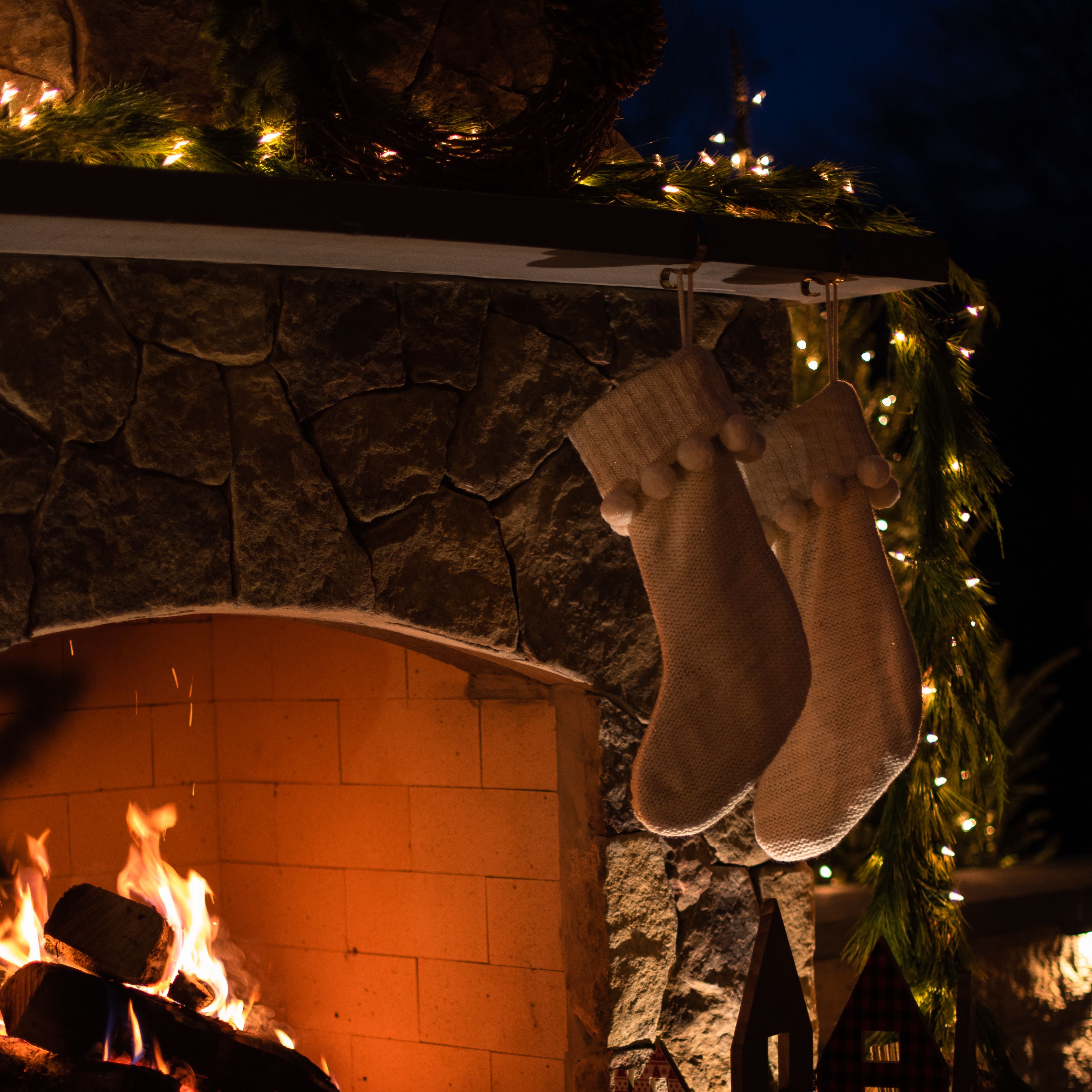 stockings hanging on decorated fireplace